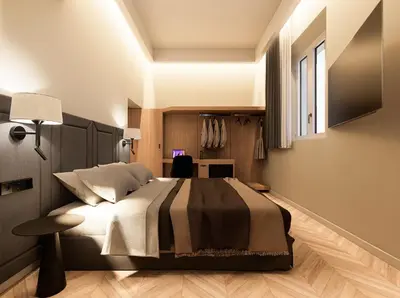 a bedroom with a large bed and a desk at Essence 55 Living in Rhodes Town