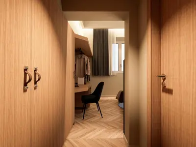 a hallway with a chair and a desk in a room at Essence 55 Living in Rhodes Town