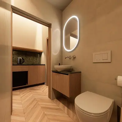 a bathroom with a toilet and a sink and a mirror at Essence 55 Living in Rhodes Town