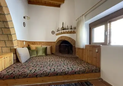 a bedroom with a bed with a fireplace at Traditional Stay in Archangelos