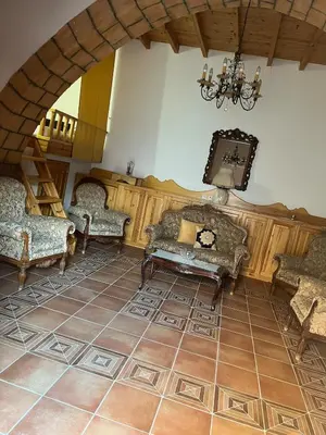 a living room with couches and a chandelier at Traditional Stay in Archangelos