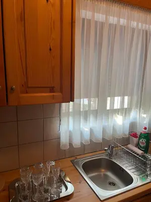 a kitchen counter with a sink and wine glasses at Traditional Stay in Archangelos