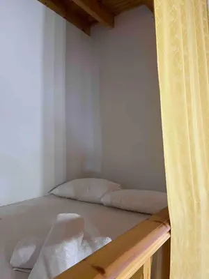 a small room with two beds in it at Traditional Stay in Archangelos