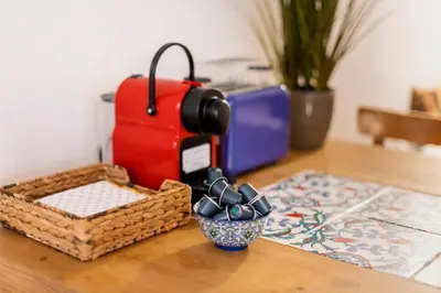 a table with a suitcase and a bowl of cookies at Maison Amandine in Rhodes Town