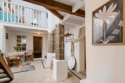 a living room with a large painting on the wall at Maison Amandine in Rhodes Town