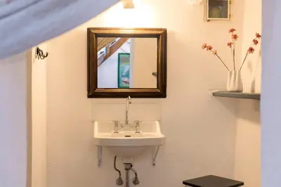 a bathroom with a sink and a mirror at Maison Amandine in Rhodes Town
