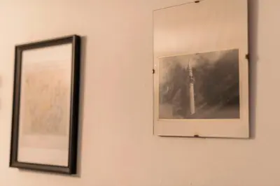 two pictures on a wall next to a mirror at Maison Amandine in Rhodes Town