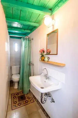 a bathroom with a sink and a green ceiling at Maison Amandine in Rhodes Town