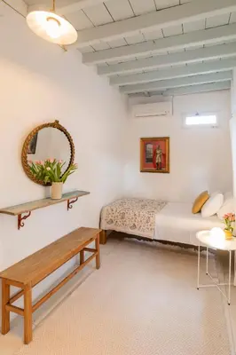a bedroom with a bed and a table at Maison Amandine in Rhodes Town