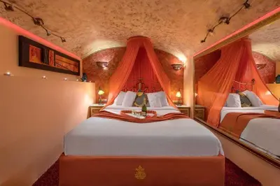 a bedroom with two beds with red drapes at boutique hotel FASHI NIK in Rhodes Town