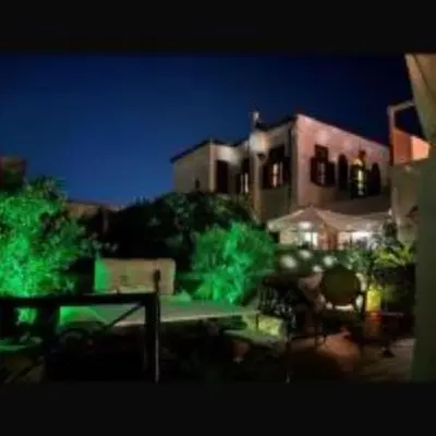 a night view of a building with green lights at boutique hotel FASHI NIK in Rhodes Town