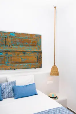 a bedroom with a bed with a painting on the wall at Lindos Portes Blue in Líndos