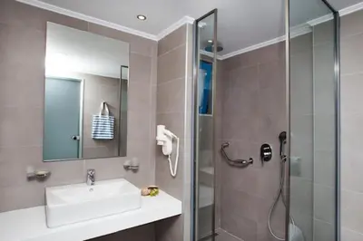 a bathroom with a shower and a sink and a shower at Lindos Portes Blue in Líndos