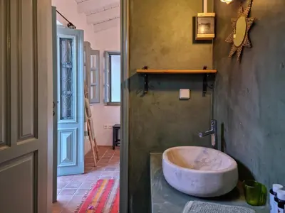 a bathroom with a large tub in a room at Symi Village House in Symi