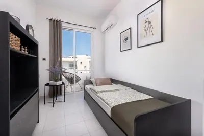 a living room with a bed and a large window at Ferienwohnung BIA Rigas in Rhodes Town