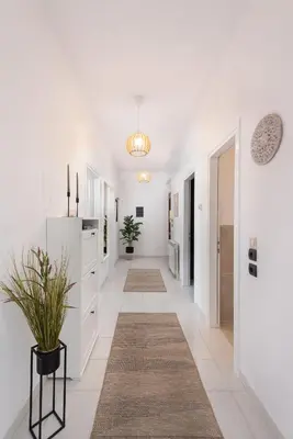 a hallway of a home with white walls and white floors at Ferienwohnung BIA Rigas in Rhodes Town