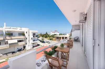 an apartment balcony with a table and chairs at Ferienwohnung BIA Rigas in Rhodes Town