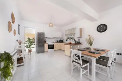 a kitchen and dining room with a table and chairs at Ferienwohnung BIA Rigas in Rhodes Town