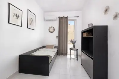 a bedroom with a bed and a tv in it at Ferienwohnung BIA Rigas in Rhodes Town