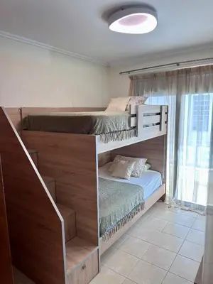 two bunk beds in a room with a staircase at Casa Verde Pastida in Pastida