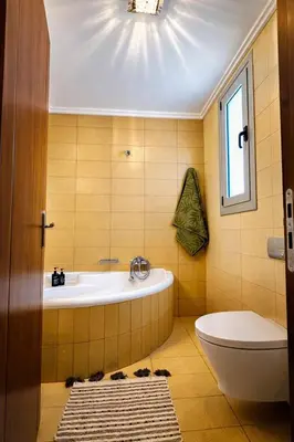a bathroom with a tub and a toilet and a window at Casa Verde Pastida in Pastida