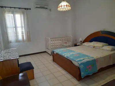 a bedroom with a bed and a crib in it at Diotima Rhodos Experience in Rhodes Town