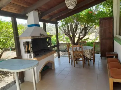 a patio with an outdoor oven with a table and chairs at Diotima Rhodos Experience in Rhodes Town