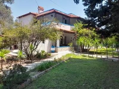 a house with a cross on the roof at Diotima Rhodos Experience in Rhodes Town