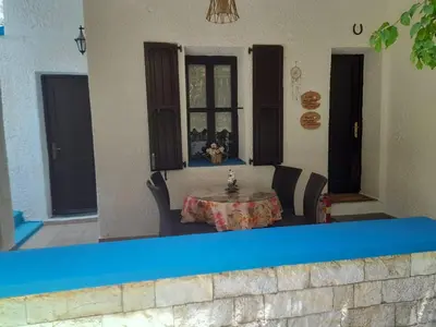 a patio with a table in the middle of a house at Diotima Rhodos Experience in Rhodes Town