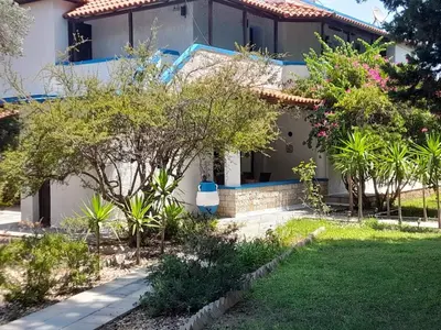 a house with a garden in front of it at Diotima Rhodos Experience in Rhodes Town