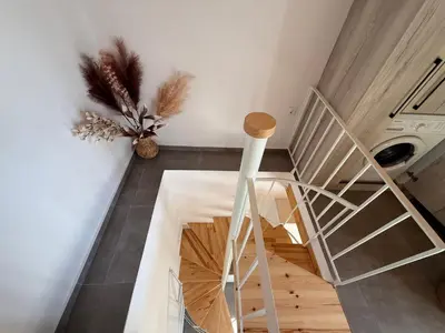 a staircase in a room with a white wall at Spitaki in Kremasti