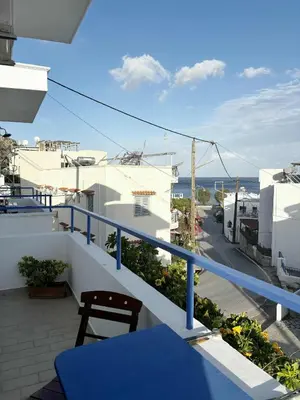 a balcony with a blue table and a view of the ocean at Blue View in Livadia