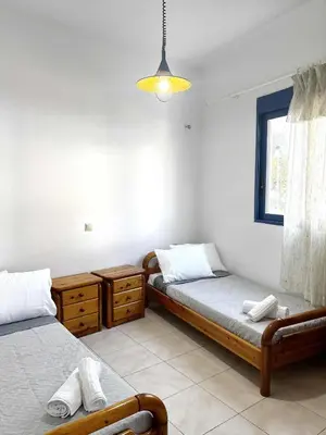 a bedroom with two beds and a window at Blue View in Livadia