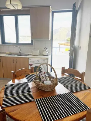 a kitchen with a wooden table with a basket on it at Blue View in Livadia
