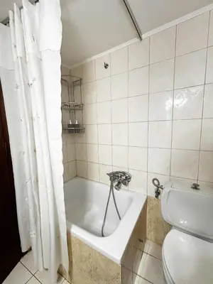 a bathroom with a bath tub and a toilet at Blue View in Livadia