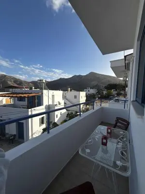 a balcony with a table and a view of a city at Blue View in Livadia