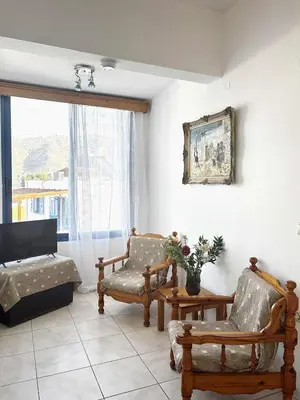 a living room with two chairs and a couch at Blue View in Livadia