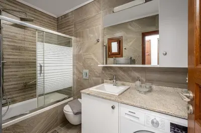 a bathroom with a sink and a shower and a toilet at Villa Yannis in Líndos