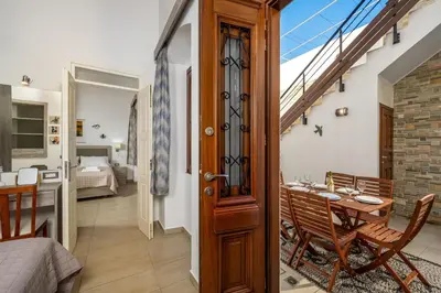 a room with a balcony with a table and a bed at Villa Yannis in Líndos