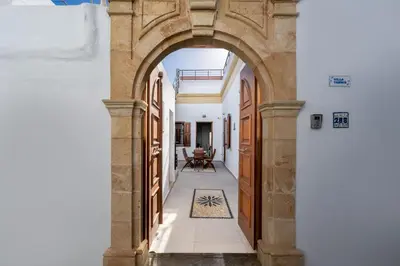 an archway leading to a courtyard in a house at Villa Yannis in Líndos