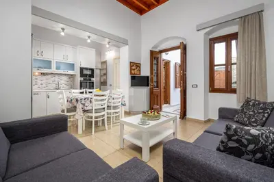 a living room with two couches and a table at Villa Yannis in Líndos