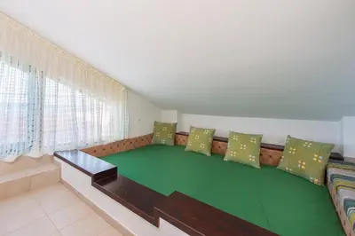 a couch with pillows in a living room at Beachfront Villa Rhodes SeaShell in Gennadi