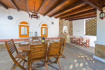 a dining room with a table and chairs at Beachfront Villa Rhodes SeaShell in Gennadi