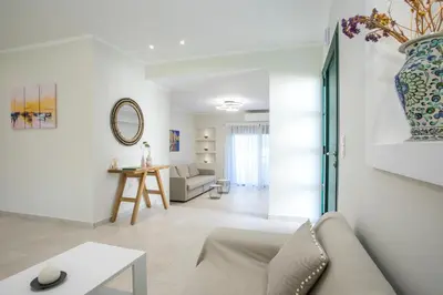 a living room with a couch and a vase on the wall at Beachfront Villa Rhodes SeaShell in Gennadi
