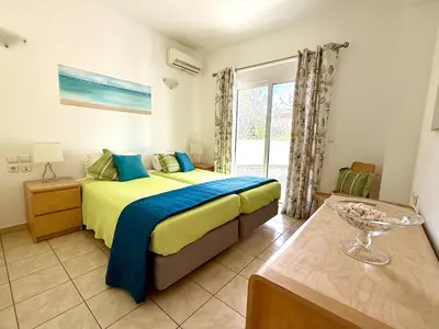 a bedroom with a bed and a window at Villa Fig Tree in Phanaes