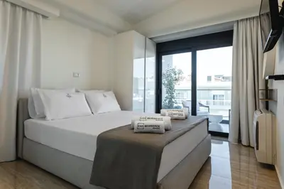 a bedroom with a bed and a large window at Unique Icon Residence in Rhodes Town