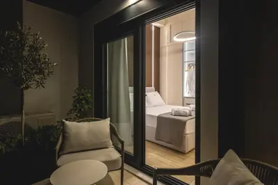 a room with a bedroom with a bed and a mirror at Unique Icon Residence in Rhodes Town