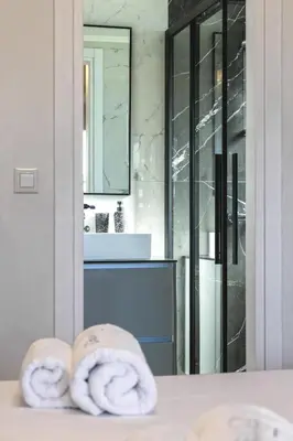a bathroom with a sink and two towels on a counter at Unique Icon Residence in Rhodes Town