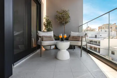 a balcony with a table and chairs on a building at Unique Icon Residence in Rhodes Town