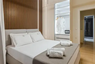 a bedroom with a bed with two towels on it at Unique Icon Residence in Rhodes Town